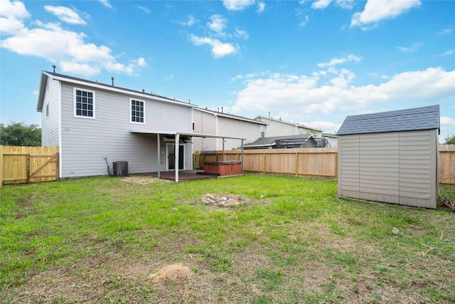 19826 Creston Cove Ct, Cypress, TX 77433 - rear view of house featuring a hot tub, a storage unit, a patio area, and an outbuilding