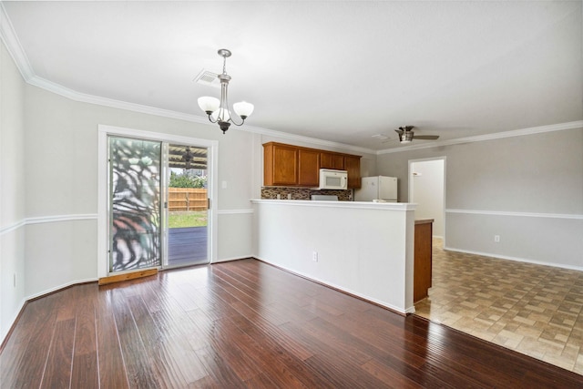 19826 Creston Cove Ct, Cypress, TX 77433 - kitchen with white appliances, a chandelier, open floor plan, brown cabinets, and a peninsula