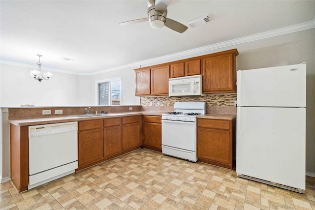 19826 Creston Cove Ct, Cypress, TX 77433 - kitchen with white appliances, crown molding, brown cabinets, a sink, and ceiling fan