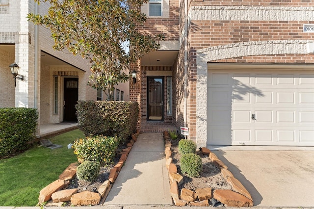 10106 Holly Chase Dr, Houston, TX 77042 - view of exterior entry featuring brick siding, an attached garage, and driveway