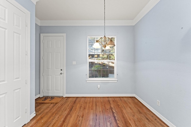 10106 Holly Chase Dr, Houston, TX 77042 - unfurnished dining area with a chandelier, crown molding, baseboards, and wood finished floors