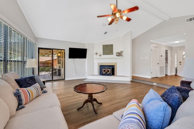 148 S Oak Bluff St, Trinity, TX 75862 - living room featuring wood finished floors, a ceiling fan, baseboards, and a fireplace