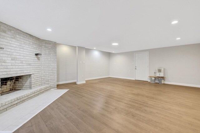 148 S Oak Bluff St, Trinity, TX 75862 - unfurnished living room featuring light wood-style floors, baseboards, recessed lighting, and a fireplace