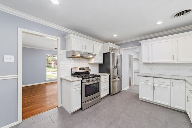 8022 Ridgeview Dr, Houston, TX 77055 - kitchen with appliances with stainless steel finishes, under cabinet range hood, light tile patterned floors, white cabinets, and ornamental molding