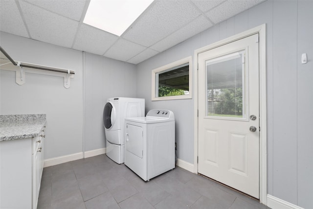 8022 Ridgeview Dr, Houston, TX 77055 - laundry room featuring washing machine and dryer, light tile patterned floors, and cabinet space