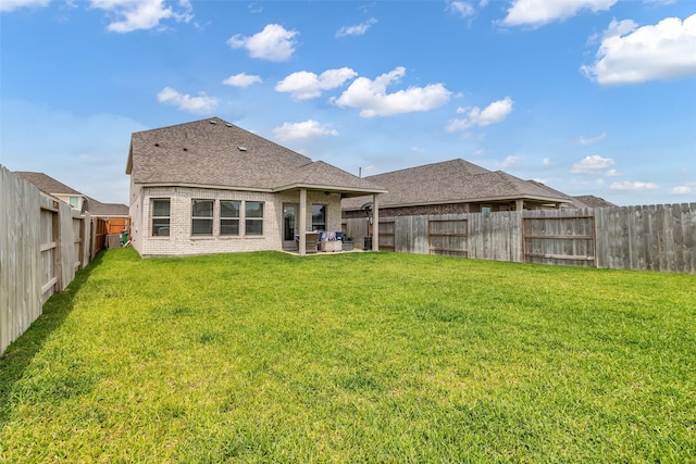 8310 Royal Breeze Dr, Cypress, TX 77433 - back of property featuring brick siding, a patio area, and roof with shingles
