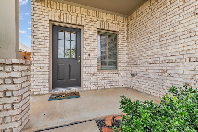 8310 Royal Breeze Dr, Cypress, TX 77433 - view of exterior entry featuring brick siding and a porch
