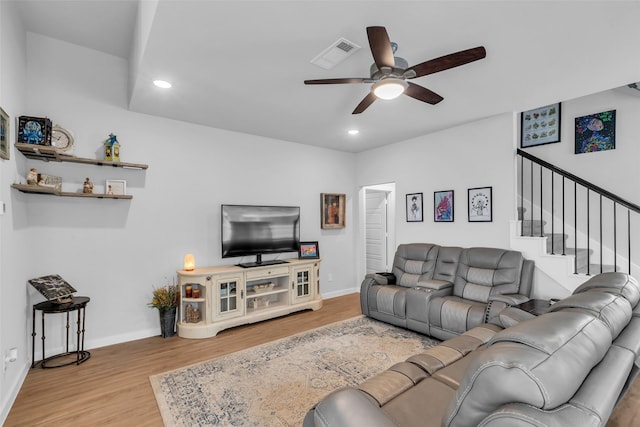 8310 Royal Breeze Dr, Cypress, TX 77433 - living area with ceiling fan, wood finished floors, recessed lighting, baseboards, and stairs