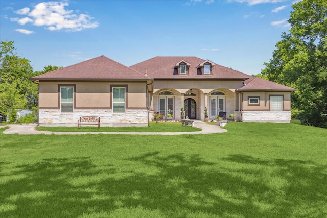 8309 Cook Rd, Manvel, TX 77578 - view of front of property with stone siding, stucco siding, a front lawn, and a shingled roof