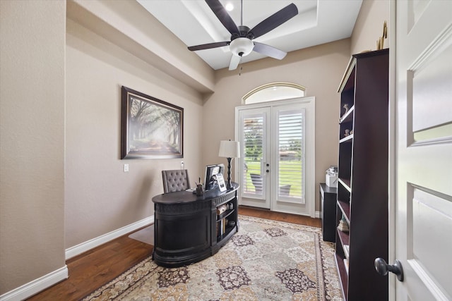 8309 Cook Rd, Manvel, TX 77578 - office area with wood finished floors, baseboards, ceiling fan, and a wood stove
