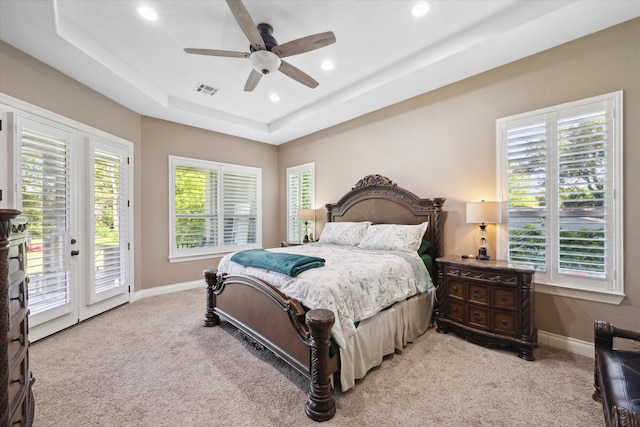 8309 Cook Rd, Manvel, TX 77578 - bedroom with light colored carpet, access to exterior, a raised ceiling, multiple windows, and recessed lighting