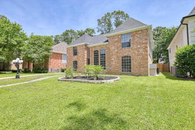 17706 August Meadows Ln, Spring, TX 77379 - view of front of property with brick siding, a shingled roof, and central AC unit