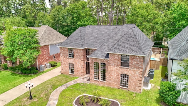 17706 August Meadows Ln, Spring, TX 77379 - rear view of property with brick siding, a shingled roof, and central AC unit