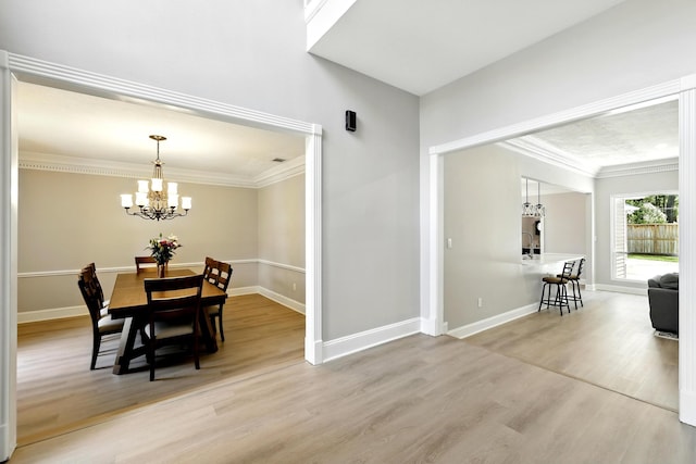 17706 August Meadows Ln, Spring, TX 77379 - dining area featuring light wood-type flooring, crown molding, a chandelier, and baseboards