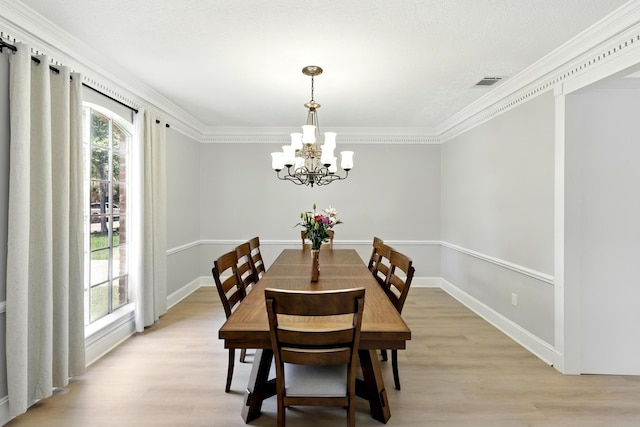 17706 August Meadows Ln, Spring, TX 77379 - dining space with a chandelier, light wood finished floors, crown molding, and baseboards