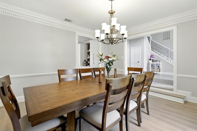 17706 August Meadows Ln, Spring, TX 77379 - dining space featuring a chandelier, crown molding, stairway, light wood finished floors, and baseboards