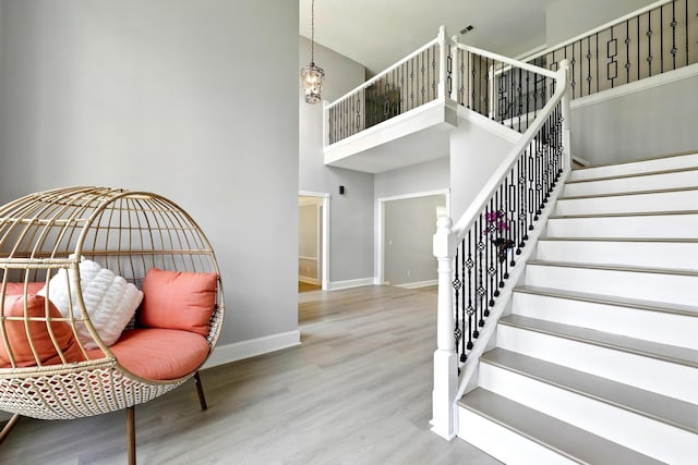 17706 August Meadows Ln, Spring, TX 77379 - stairs with baseboards, a high ceiling, and wood finished floors