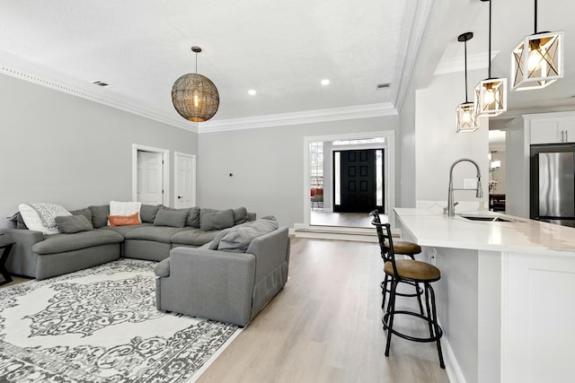 17706 August Meadows Ln, Spring, TX 77379 - living room featuring light wood-type flooring, crown molding, recessed lighting, and baseboards