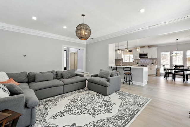 17706 August Meadows Ln, Spring, TX 77379 - living room featuring a chandelier, light wood-style flooring, crown molding, and recessed lighting