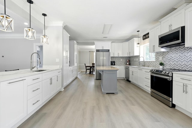 17706 August Meadows Ln, Spring, TX 77379 - kitchen featuring appliances with stainless steel finishes, a sink, decorative backsplash, white cabinetry, and ornamental molding