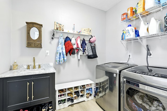 17706 August Meadows Ln, Spring, TX 77379 - laundry room featuring washing machine and clothes dryer, cabinet space, and light wood-style floors