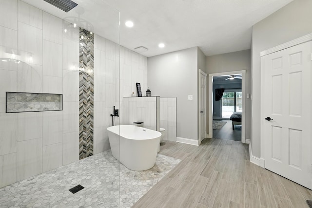 17706 August Meadows Ln, Spring, TX 77379 - ensuite bathroom with a walk in shower, wood finished floors, baseboards, a soaking tub, and toilet