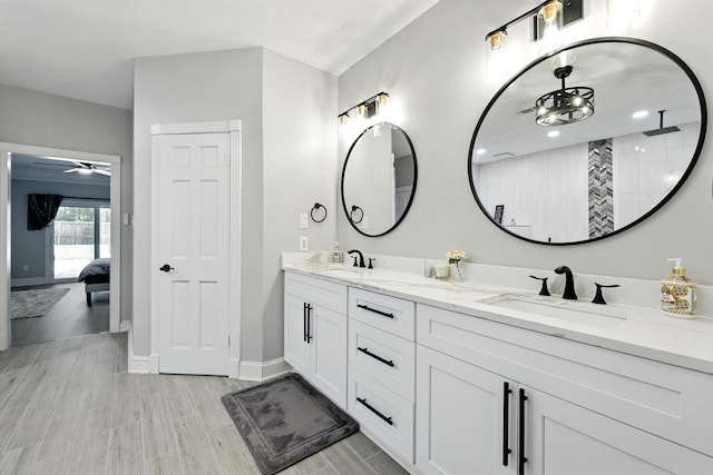 17706 August Meadows Ln, Spring, TX 77379 - bathroom with double vanity, baseboards, a ceiling fan, a tile shower, and ensuite bath