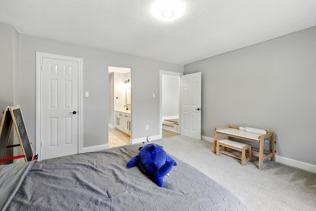 17706 August Meadows Ln, Spring, TX 77379 - bedroom featuring light carpet, connected bathroom, and baseboards
