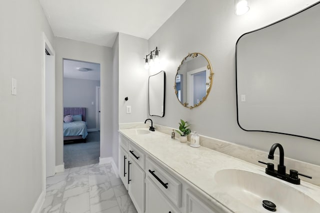 17706 August Meadows Ln, Spring, TX 77379 - bathroom featuring marble finish floors, baseboards, double vanity, and ensuite bath