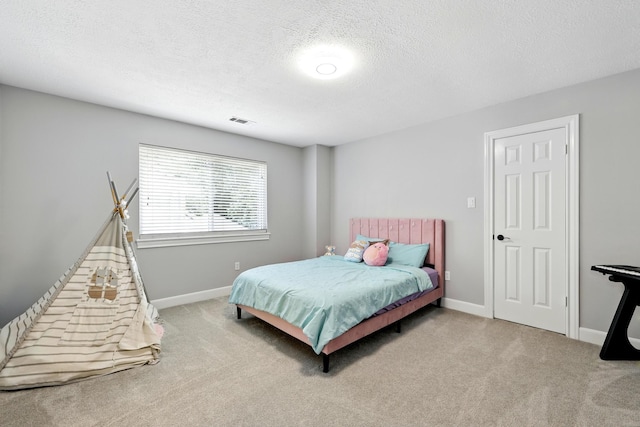 17706 August Meadows Ln, Spring, TX 77379 - bedroom featuring carpet, a textured ceiling, and baseboards