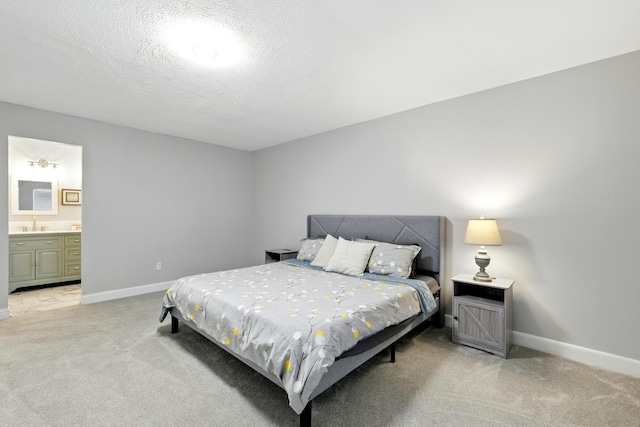 17706 August Meadows Ln, Spring, TX 77379 - bedroom with light colored carpet, baseboards, a textured ceiling, and ensuite bathroom