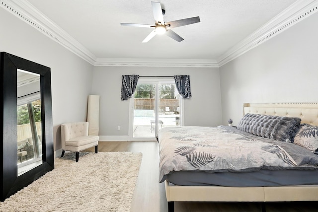 17706 August Meadows Ln, Spring, TX 77379 - bedroom featuring access to outside, crown molding, wood finished floors, multiple windows, and ceiling fan