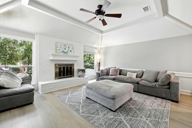17706 August Meadows Ln, Spring, TX 77379 - living area with healthy amount of natural light, ceiling fan, wood finished floors, a brick fireplace, and vaulted ceiling