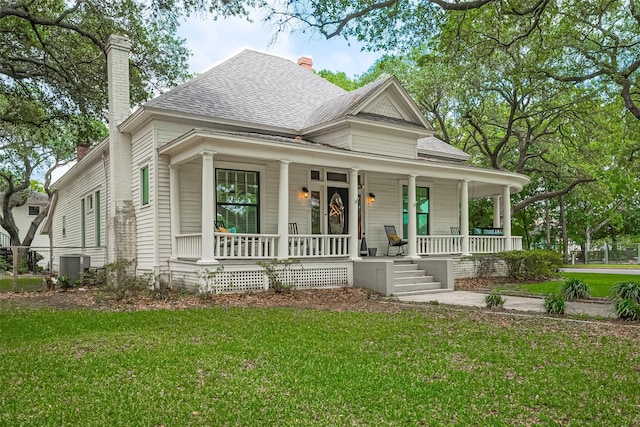 500 W Post Office St, Eagle Lake, TX 77434 - view of front of property featuring a porch, central air condition unit, a shingled roof, and a chimney