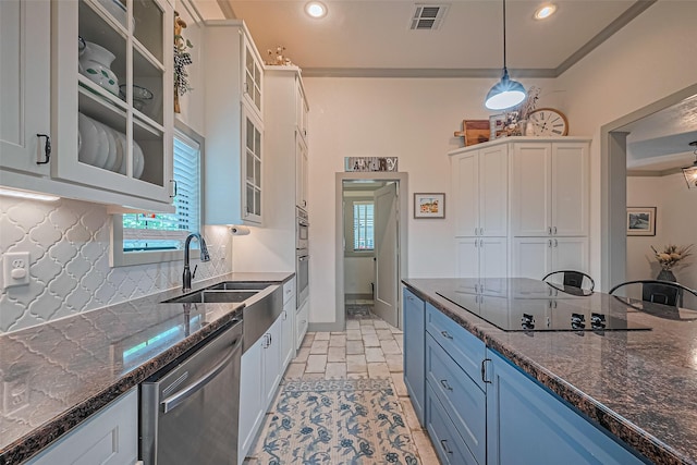 500 W Post Office St, Eagle Lake, TX 77434 - kitchen with stainless steel appliances, white cabinets, a sink, backsplash, and dark stone countertops