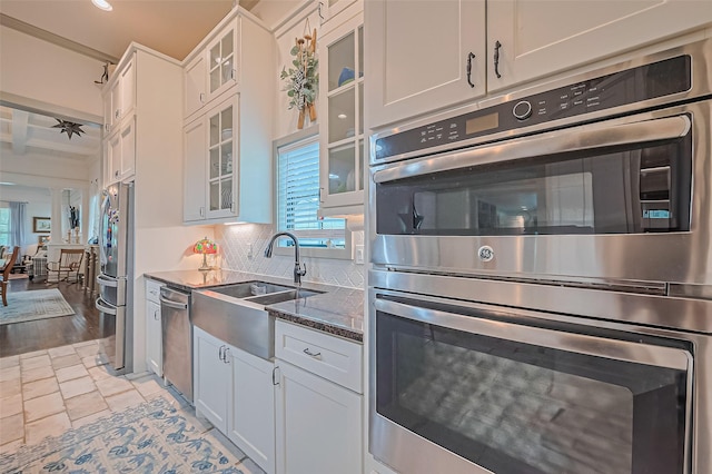 500 W Post Office St, Eagle Lake, TX 77434 - kitchen with appliances with stainless steel finishes, healthy amount of natural light, a sink, dark stone counters, and recessed lighting