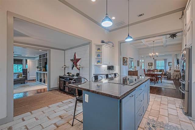 500 W Post Office St, Eagle Lake, TX 77434 - kitchen featuring black electric cooktop, white cabinetry, a breakfast bar area, coffered ceiling, and a chandelier