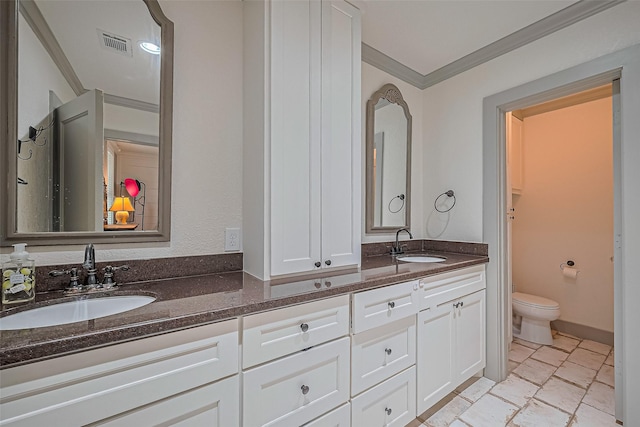 500 W Post Office St, Eagle Lake, TX 77434 - bathroom with crown molding, toilet, double vanity, and stone finish flooring