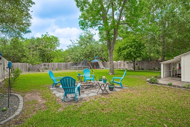 500 W Post Office St, Eagle Lake, TX 77434 - view of yard featuring a trampoline, an outdoor fire pit, a patio area, and a playground