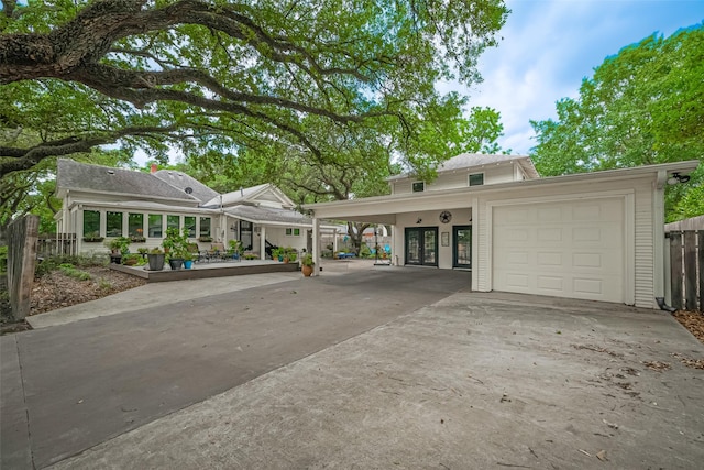 500 W Post Office St, Eagle Lake, TX 77434 - view of front of property with driveway, french doors, fence, and a carport