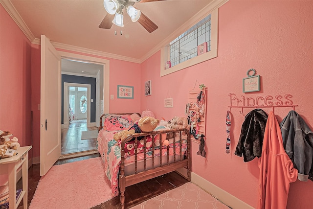 500 W Post Office St, Eagle Lake, TX 77434 - bedroom featuring crown molding, baseboards, wood finished floors, and ceiling fan
