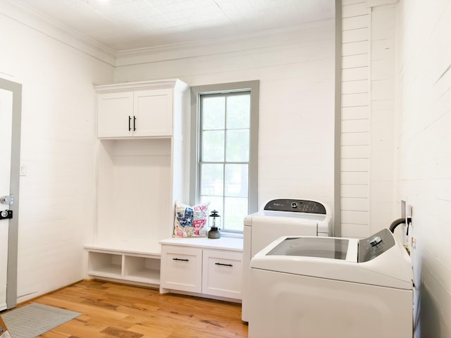1111 Fm 109, New Ulm, TX 78950 - laundry room with washer and dryer, ornamental molding, cabinet space, and light wood-style floors
