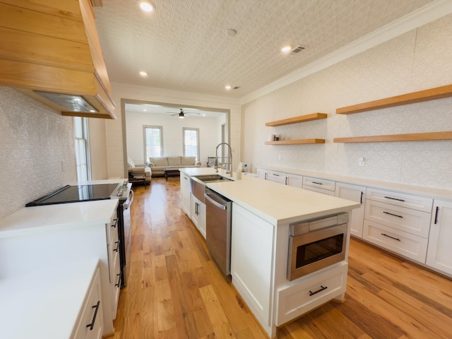 1111 Fm 109, New Ulm, TX 78950 - kitchen featuring crown molding, appliances with stainless steel finishes, custom exhaust hood, open floor plan, and white cabinets