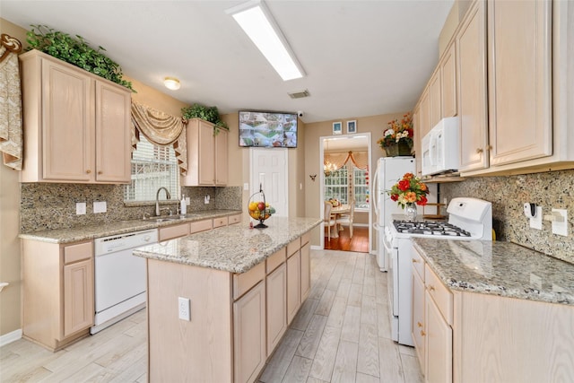 6610 Golden View Ct, Houston, TX 77083 - kitchen featuring white appliances, a sink, light wood-style flooring, a kitchen island, and light brown cabinets