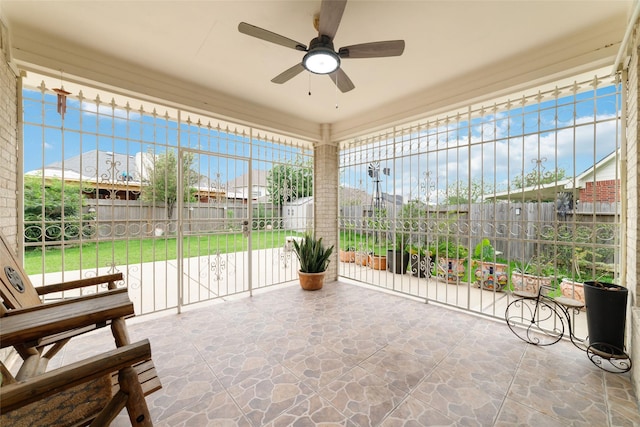 6610 Golden View Ct, Houston, TX 77083 - unfurnished sunroom with stone floors, a ceiling fan, and plenty of natural light