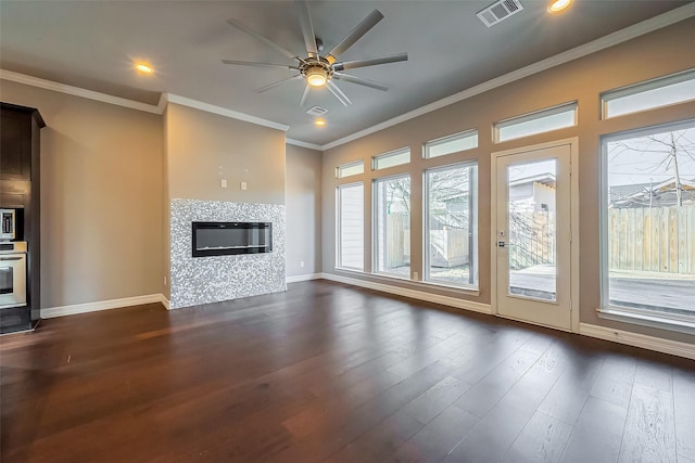 4307 Hershe St, Houston, TX 77020 - unfurnished living room with a ceiling fan, ornamental molding, dark wood finished floors, baseboards, and a tiled fireplace