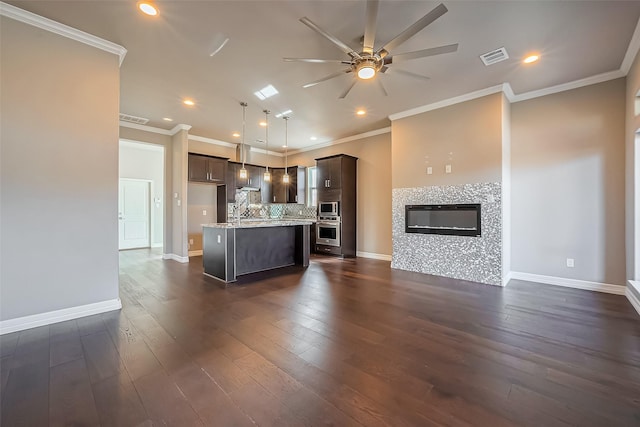 4307 Hershe St, Houston, TX 77020 - kitchen with appliances with stainless steel finishes, open floor plan, a ceiling fan, dark brown cabinetry, and baseboards