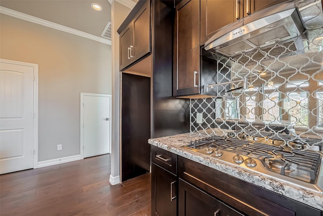 4307 Hershe St, Houston, TX 77020 - kitchen with stainless steel gas stovetop, crown molding, ventilation hood, decorative backsplash, and baseboards