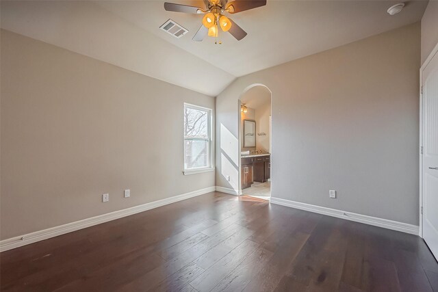 4307 Hershe St, Houston, TX 77020 - unfurnished room featuring a ceiling fan, arched walkways, baseboards, dark wood-style floors, and vaulted ceiling