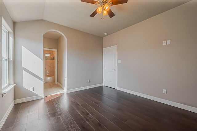 4307 Hershe St, Houston, TX 77020 - unfurnished room featuring arched walkways, dark wood-style floors, vaulted ceiling, a ceiling fan, and baseboards